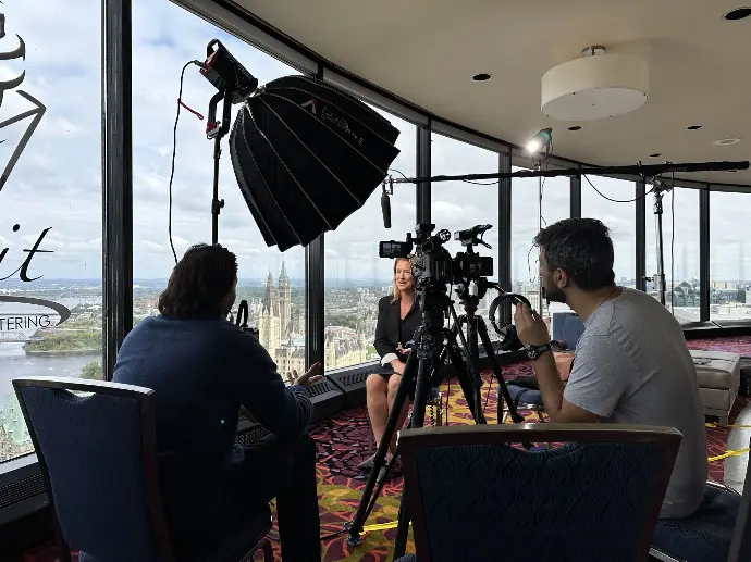 behind the scenes on a shoot with at mainspring agency video production company, a woman is being interviewed