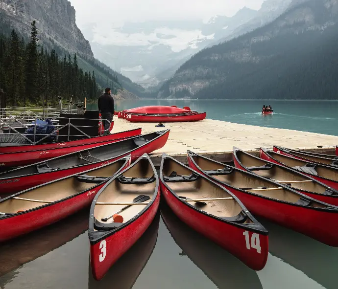 brilliant red boats at a dock on lake louise, ab