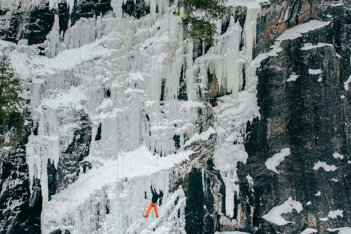 an idea climber scales a frozen waterfall captured by mainspring agency