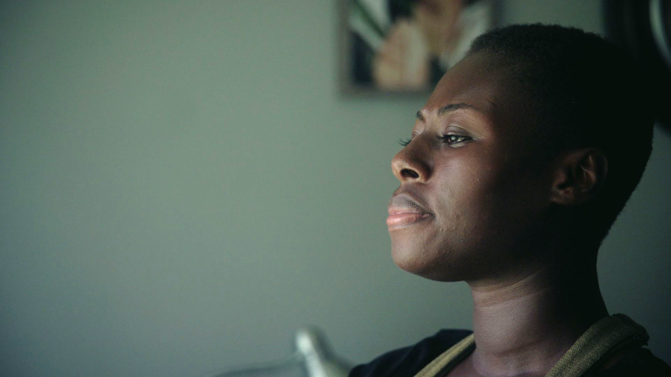 thumbnail for documentaries, showing a black woman looking pensively out of the window
