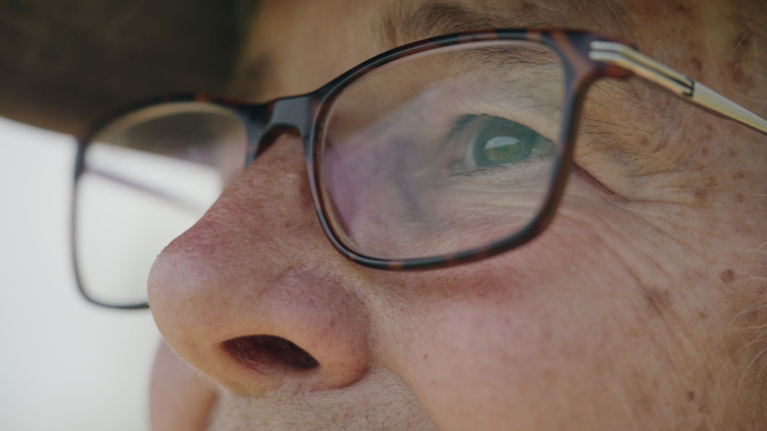 a close up of the soulful eyes of a lady in her 60s, looking pensive and contemplating, production still from mainspring agency's documentary salted earth