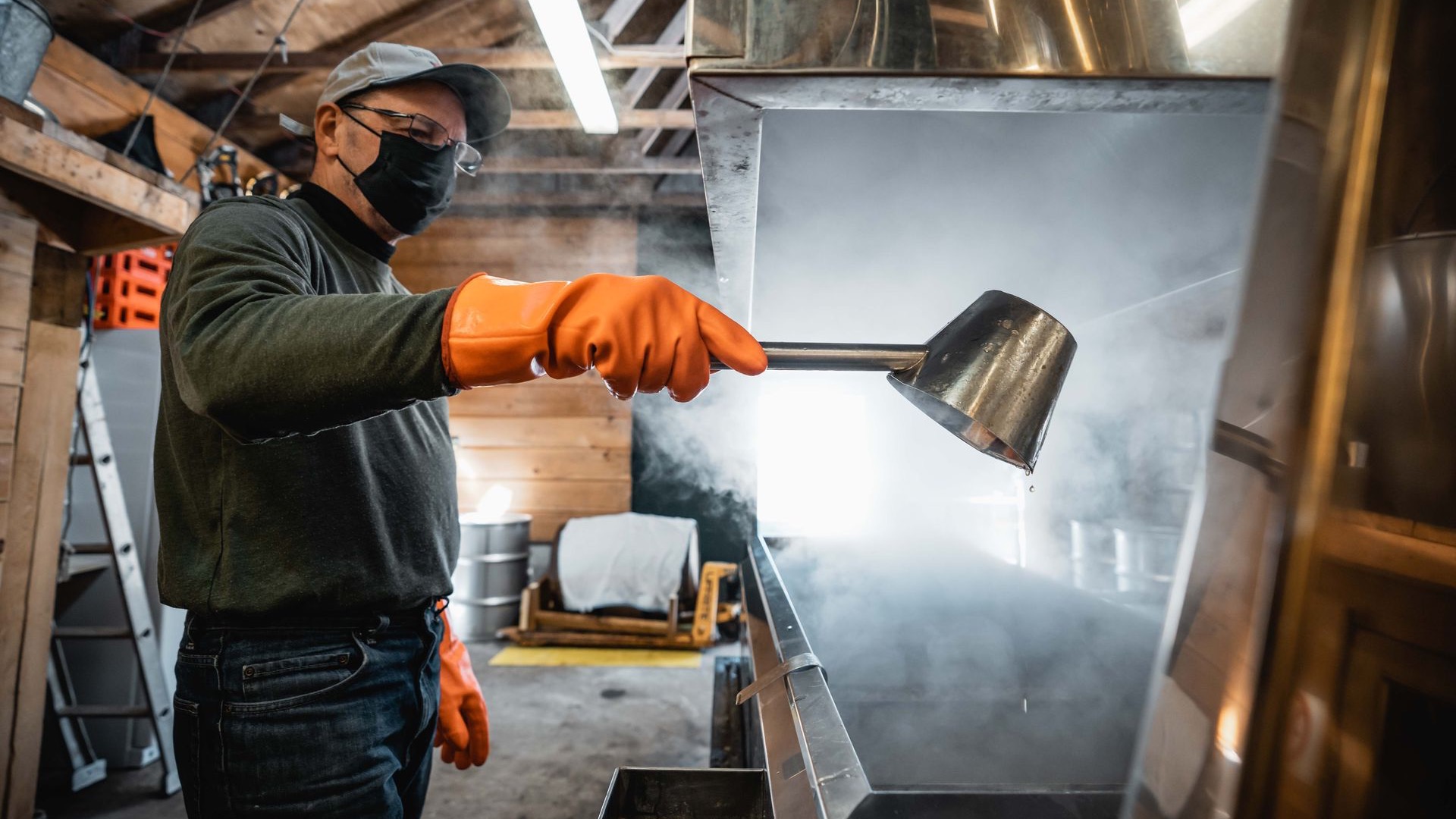 a maple syrup producer in lanark county surrounded by steam as he boils down the sap into syrup